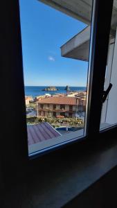 a view of the ocean from a window at Hotel Lachea in Acitrezza