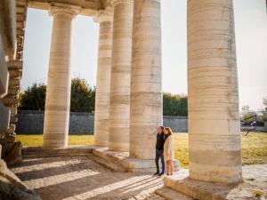 an image of a couple standing in front of columns at La Saline Royale in Arc-et-Senans