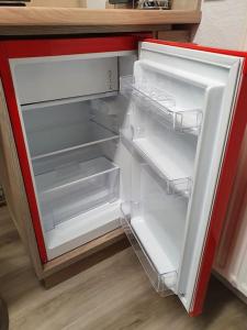 an empty refrigerator with its door open in a kitchen at Fuchsbau Haasow in Haasow +10 photos