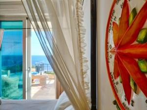 a bedroom with a window with a view of the ocean at The Lookout in Marina Porto