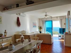 a kitchen and living room with a view of the ocean at The Lookout in Marina Porto