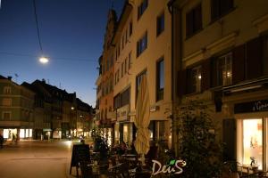 an empty city street at night with a building at Ferienwohnung DEU5 in Bregenz