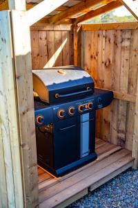 a grill sitting in the inside of a wooden building at Ravens Rest Retreat 