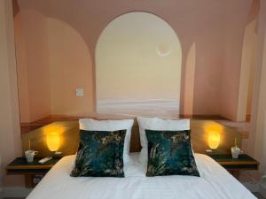 a bedroom with a bed with two pillows on it at Mélisande au pays des orjouliers in Saint-Jean-de-Fos +99 photos