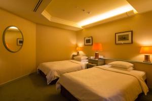 Voodi või voodid majutusasutuse Awashima Hotel toas