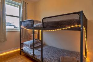 two bunk beds in a room with lights at Finest Retreats - Kanangra in Teignmouth