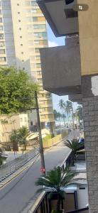 a view of a street with palm trees and buildings at Joia Da Pitangueiras in Guarujá +21 photos