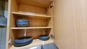 two blue plates are sitting in a cupboard at Excellent 2 Bedroom City Centre Apartment in Sheffield
