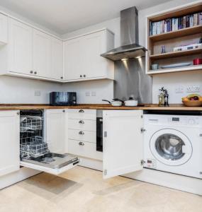 a kitchen with white cabinets and a dishwasher at Zs Apartments - St Albans City Centre - 20 mins from London in St. Albans