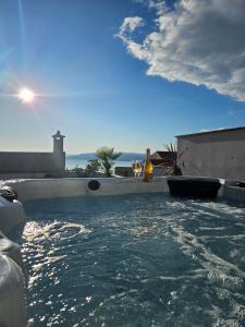 a swimming pool with water in a house at Apartman Koko with private jacuzzi in Makarska