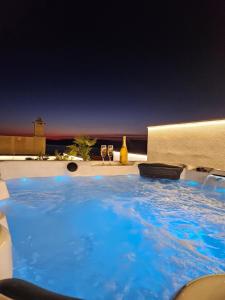 a large blue swimming pool sitting on top of a building at Apartman Koko with private jacuzzi in Makarska