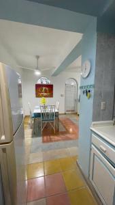 a kitchen and dining room with a table and a refrigerator at Caribbean Paradise steps to DayPass Resort&Beach in La Laguna