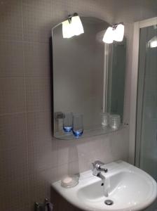 a bathroom with a sink and a mirror and glasses at Apartment Tanja in Kranjska Gora