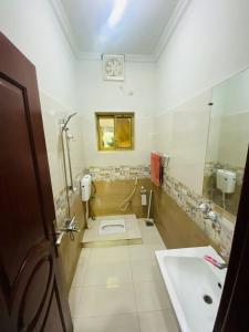 a bathroom with a sink and a shower and a toilet at Kashee's Lodges in Islamabad