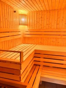 a wooden sauna with wooden floors and ceilings at VitaPark Borysfen in Kyiv
