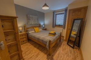 una camera da letto con un letto con cuscini gialli di Quay Head View Aparthotel a Stranraer