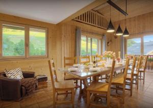 a dining room with a long table and chairs at Chalet Joubarbe - Les Congères in Le Grand-Bornand
