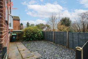 a fence in a yard next to a house at Spacious 2 bedroom-Birmingham/sleeps 8/freeparking in Birmingham
