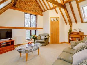 a living room with a table and a tv at 2 Bed in Reedham 90882 in Cantley