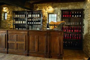 a bar with a bunch of bottles of wine at Castello di Viano in Viano