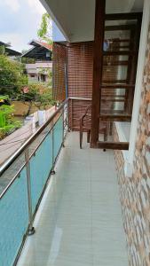Un balcón de una casa con una mesa y un banco en Juliet's Homestay, en Kochi