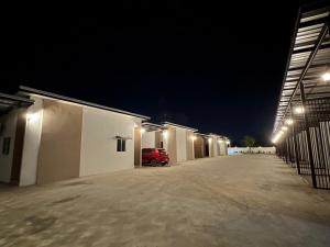 a car parked in a garage at night at 24 Sleep Resort Khlong Luang Hospital in Khlong Luang