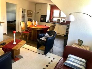 a living room and kitchen with a table and chairs at Ferien in Schluchsee in Schluchsee