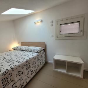 a small bedroom with a bed and a window at Aros Mountain Lake Iseo Hospitaliy in Pisogne
