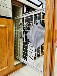 a kitchen door with a rack of kitchen utensils at Stayinn Itoshima - Vacation Rental in Itoshima +46 photos