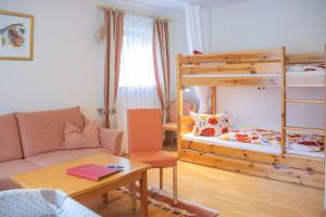 a small room with a bunk bed and a couch at Hotel - Gasthof Blume in Oppenau