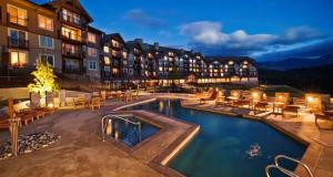 a hotel with a swimming pool in front of a building at 4008 Cozy ONE Bedroom in Suncadia with Heated Pool Access in Cle Elum