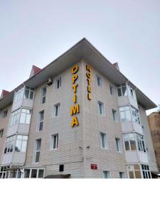 a hotel with a sign on the side of it at Optima Kropivnytskiy Hotel in Kropyvnytskyi