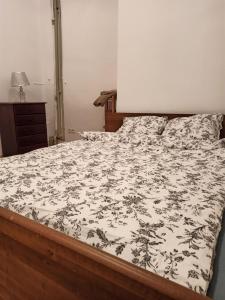 a bedroom with a bed with a black and white comforter at Rooms in the Centrum in Warsaw