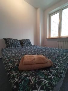 a bed in a bedroom with a blanket with a pillow at Rooms in the Centrum in Warsaw