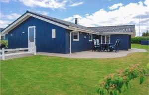 niebieska szopa ze stołem i krzesłami na dziedzińcu w obiekcie Stunning Home In Haderslev With 4 Bedrooms, Sauna And Wifi w mieście Årøsund