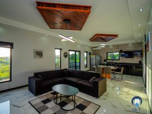 a living room with a couch and a table at Luxury Sky Residence Penthouse in Paramaribo