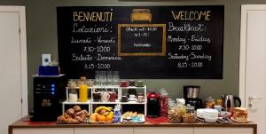 a counter with a chalkboard with a bunch of food at Al Binario Brescia in Brescia