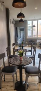 a group of tables and chairs in a room at Al Binario Brescia in Brescia