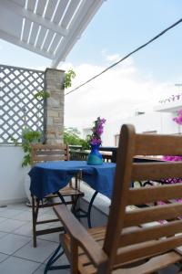 a table with a blue table cloth on a patio at Studios Stratos in Naxos Chora