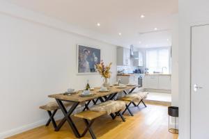 a dining room with a table and four chairs at Luxury 5 Bedroom House By The Sea in Brighton & Hove