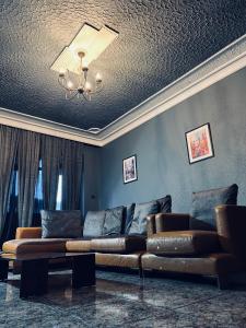 a living room with a couch and a ceiling at Central Apartment Black Cat in Karlovo