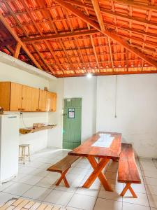 a kitchen with a wooden table in a room at Ótima casa no centro de Carrancas in Carrancas