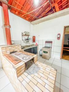 a kitchen with a stove and a stove top oven at Ótima casa no centro de Carrancas in Carrancas