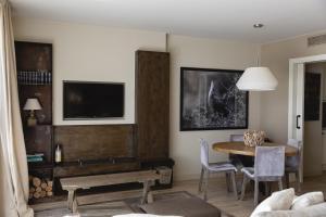 a living room with a table and a tv at Emporda Golf 28 2-1 in Gualta