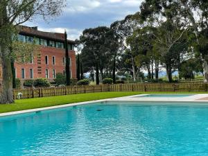 a swimming pool in front of a brick building at Emporda Golf 28 2-1 in Gualta