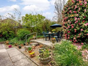 a garden with a table and chairs and flowers at 2 bed in Bexhill on Sea 82747 in Sidley
