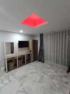 a red ceiling in a room with a television at dara otel in Midyat