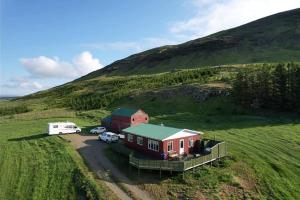 an aerial view of a house and a van parked in a field at Erpsstadir Cottage in Sauðafell