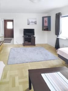 sala de estar con TV de pantalla plana y sofá en Fritidshus - Cottage - Holiday house - Soluppgång, en Blattniksele