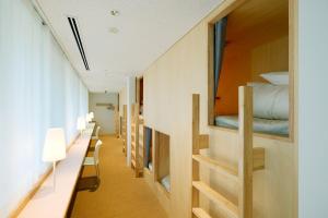 a corridor of a room with bunk beds at BONAPOOL in Onomichi